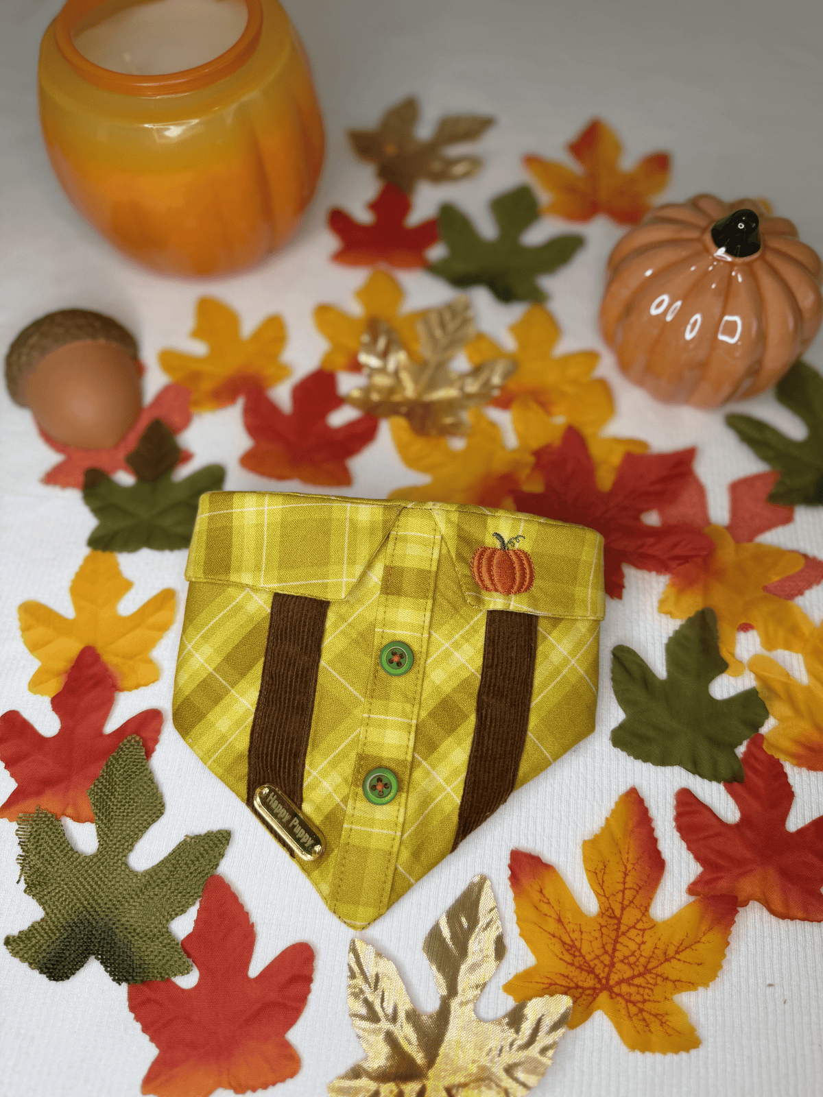 Detalle de la bandana para perro Pumpkin Spice de Happy Puppy Bandanas en cuadros amarillo mostaza con tirantes marrones y calabaza bordada